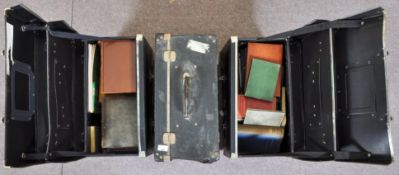 Three black cases containing books