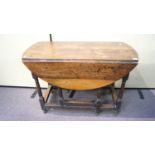 A 19th Century oak drop leaf and gate leg oval dining table,