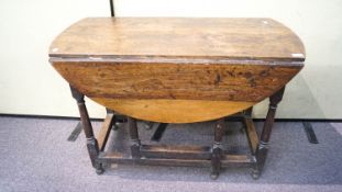 A 19th Century oak drop leaf and gate leg oval dining table,