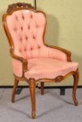 A contemporary French carved salon chair in striped pink upholstery.