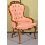 A contemporary French carved salon chair in striped pink upholstery.