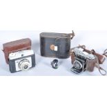 An Ilford cased camera, Certo Dollino cased camera and a case set of binoculars.