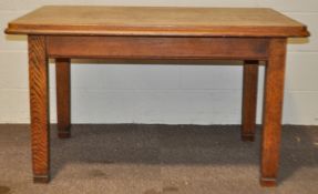 A 20th Century Arts & Crafts oak dining table of rectangular form, raised on squared legs.