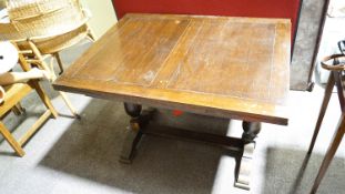 A 1940's oak draw leaf rectangular table raised on a splayed foot. Measures; 77cm x 106cm x 43cm.