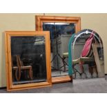 Three mirrors to include two wooden framed examples and a frameless example. Measures; 93cm x 68cm.