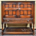 A 20th Century Ercol colonial cupboard over drawer. Measure; 91cm x 91cm x 41cm.