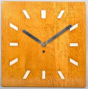 A 20th Century golden oak cased eight day wall clock with squared face.