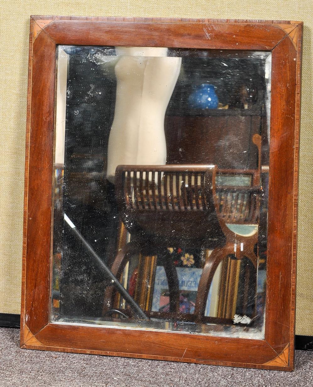 A mahogany mirror frame, with decorated spandrels, set a bevelled plate glass,