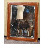 A mahogany mirror frame, with decorated spandrels, set a bevelled plate glass,