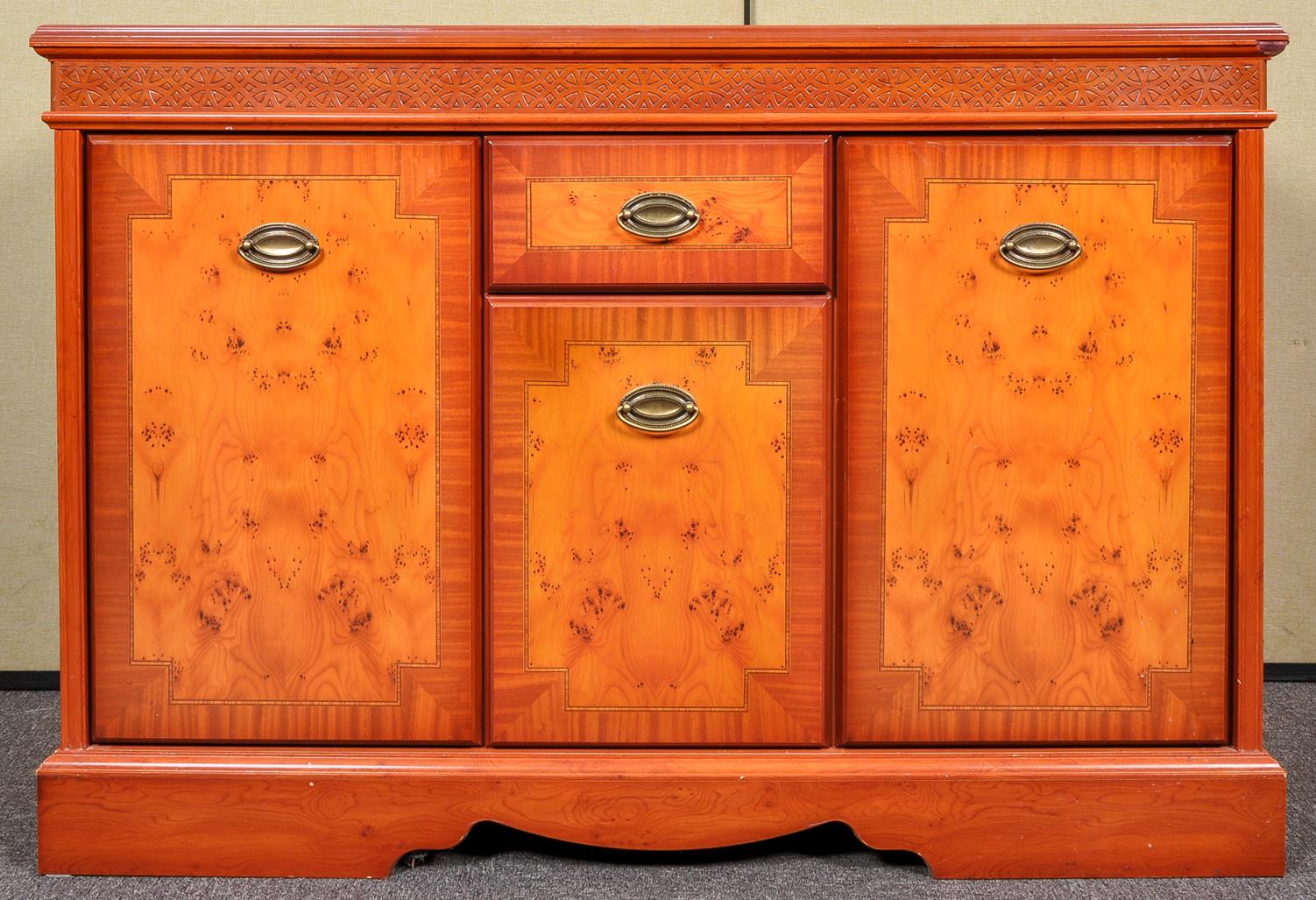 A reproduction yew wood sideboard
