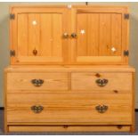 A pine two door cupboard along with low two drawers media unit/chest.