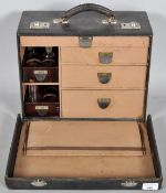 A vintage doctors case with draers and bottle stands to tthe inside