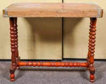 A Victorian centre table with copper top, raised on bobbin turned supports and splayed feet.