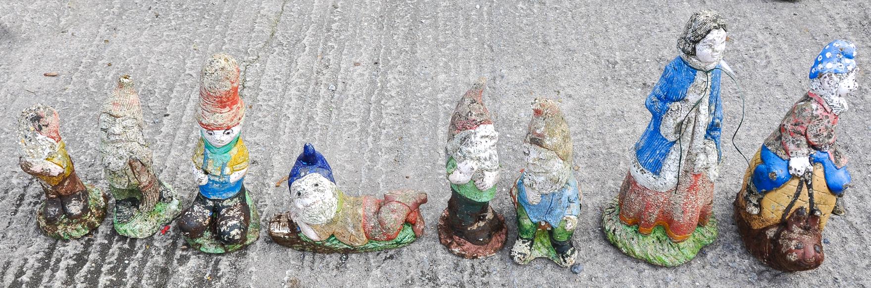 Eight composite stone garden gnomes