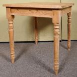 A small square pine kitchen table raised on turned legs. Measures; 76cm x 75cm x 76cm.