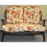 An 1980's Ercol style retro vintage two seat sofa settee having a spindle backrest,