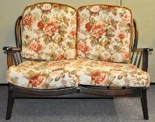 An 1980's Ercol style retro vintage two seat sofa settee having a spindle backrest,