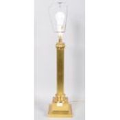 A large brass Corinthian column electric lamp base with harp raised on squared flared base.