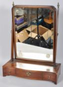 A 19th Century mahogany toilet swing mirror having a shaped mirror