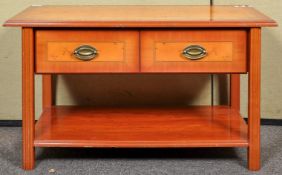 A reproduction yew wood two tier coffee table having a two drawer frieze,