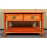 A reproduction yew wood two tier coffee table having a two drawer frieze,