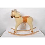 A small child's corduroy rocking horse