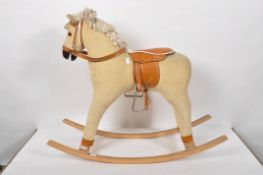 A small child's corduroy rocking horse