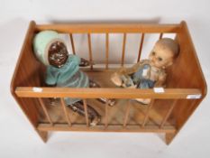 A dolls cradle and two dolls