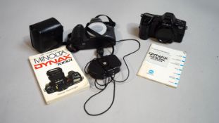 Two Minolta cameras, with instruction books,