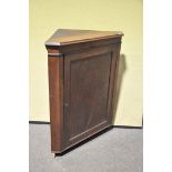 A mahogany corner cabinet