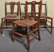 A set of four Edwardian mahogany chairs with pierced splat back, upholstered and padded seat,