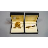 A Dunhill gold plated tie bar and a pair of cufflinks,