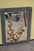 A framed painted mirror