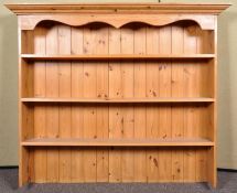A pine three shelved dresser top with flared cornice top. Measures; 121cm x 147cm.