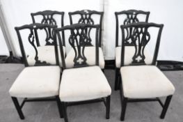A set of six ebonised dining chairs