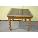 An oak draw leaf table with barley twist legs