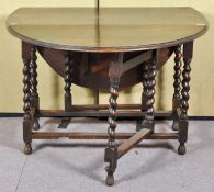 An oak barley twist drop leaf and gate leg dining table. Measures; 73cm x 108cm x 55cm.