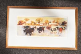 A framed and glazed print depicting cows.