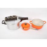 Two Le Creuset pans and a pressure cooker