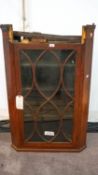 A mahogany corner cabinet