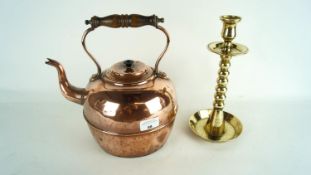 A brass candlestick and a copper kettle