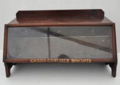 A wooden Carrs biscuits display cabinet