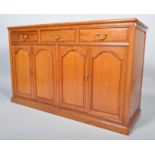 A 20th century Chinese rosewood sideboard, having a three drawer over cupboards configuration,