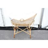 A wicker baby crib (moses basket)