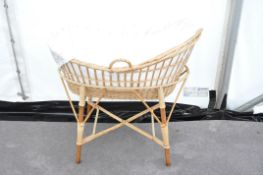 A wicker baby crib (moses basket)