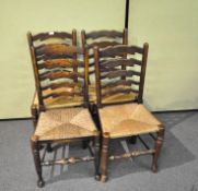 Four elm kitchen chairs with rush seats with scroll carved ladder backs