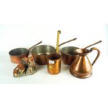 A group of copper cookware and a David Winter house