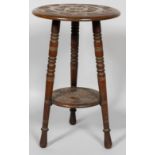 A Victorian carved wood two tier occasional table, late 19th century,