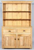 A Victorian pine kitchen dresser, late 19th century, the dresser with two fixed shelves and hooks,