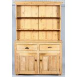 A Victorian pine kitchen dresser, late 19th century, the dresser with two fixed shelves and hooks,